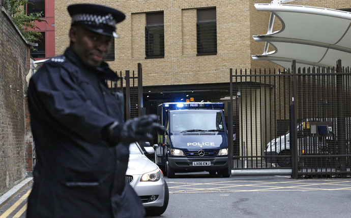 A police officer guards the rear entrance of Westminster Magistrates Court as the van carrying bombing suspect John Downey leaves, in London May 22, 2013. (Reuters)