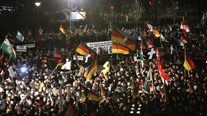 Supporters of anti-immigration movement Patriotic Europeans Against the Islamisation of the West (PEGIDA) hold flags during a demonstration in Dresden January 12, 2015. (Reuters / Fabrizio Bensch)