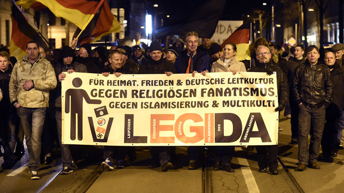 People with a poster reading 'For the fatherland, peace, German culture, against religious bigotry, against islamization and multi culture' attend a rally of LEGIDA, a local copycat of Dresden's right-wing populist movement PEGIDA (Patriotic Europeans Against the Islamisation of the Occident), in Leipzig, eastern Germany on January 12, 2015. (AFP Photo / Odd Anderen)