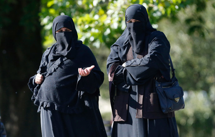 Two women wearing full-face veils walk in Regents Park in London. (Reuters / Suzanne Plunkett)