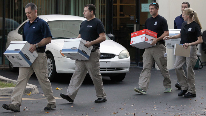 Law enforcement officials remove boxes of material from the office of Med-Care Diabetic & Medical Supplies Inc. in Boca Raton, Florida January 14, 2015.(Reuters / Andrew Innerarity) 