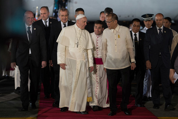 In this handout picture released by the Vatican press office (Osservatore Romano), Pope Francis (L) arrives in the Philippines in Manila on January 15, 2015. (AFP Photo/Osservatore Romano)