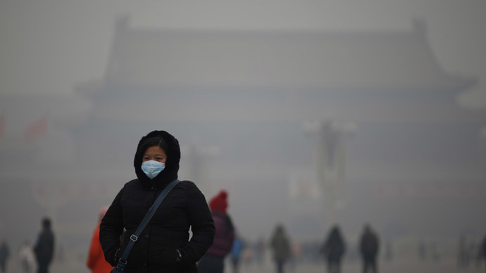 A woman wearing a mask makes her way during a polluted day at Tiananmen Square in Beijing January 15, 2015. (Reuters/Kim Kyung-Hoon)