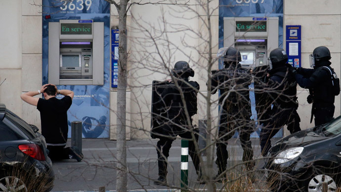 A suspect in a hostage taking situation is detained by members of special French RAID forces outside the post offices in Colombes outside Paris, January 16, 2015.(Reuters / Philippe Wojazer)