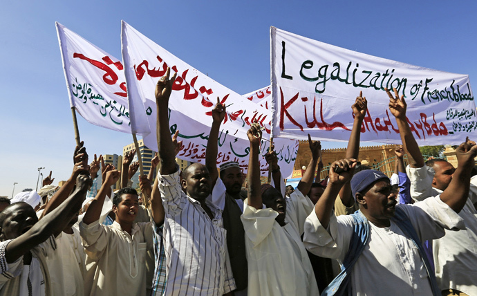 Muslims shout slogans against France and call for its apology while carrying banners during a demonstration against satirical French weekly Charlie Hebdo, which featured a cartoon of the Prophet Mohammad as the cover of its first edition since an attack by Islamist gunmen, after attending Jumma prayer in Khartoum January 16, 2015. (Reuters / Mohamed Nureldin Abdallah)
