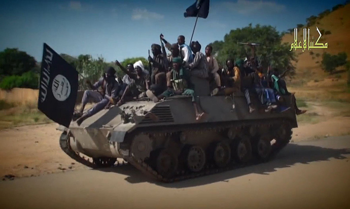 Boko Haram fighters parading on a tank in an unidentified town. (AFP Photo / HO / Boko Haram)