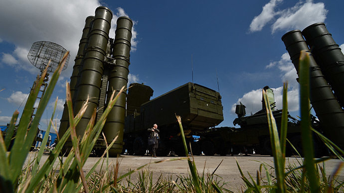 A visitor stands near an S-300 surface-to-air missile system as preparations are underway for the Engineering Technologies 2014 international forum in Zhukovsky near Moscow. (RIA Novosti/Ramil Sitdikov)
