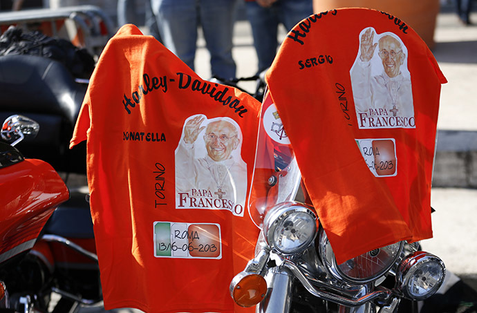 T-shirts with pictures of Pope Francis are hung over a Harley-Davidson bike before a mass led by Pope Francis in Rome June 16, 2013. (Reuters/Max Rossi)