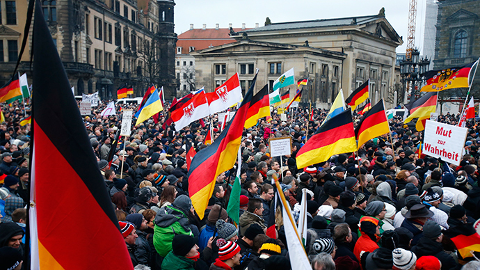 Members of the movement of Patriotic Europeans Against the Islamisation of the West (PEGIDA) hold flags and banners during a PEGIDA demonstration march in Dresden, January 25, 2015 (Reuters / Hannibal Hanschke)