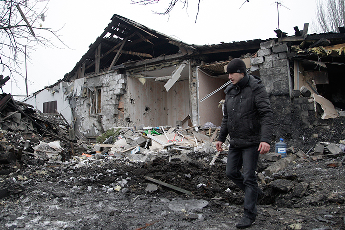 A man walks near a damaged residential building in Donetsk, eastern Ukraine January 19, 2015 (Reuters / Alexander Ermochenko)