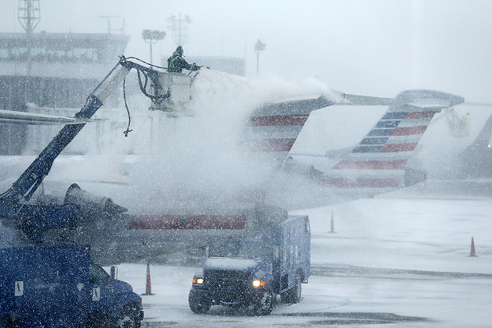 An airport worker de-ices an airplane at LaGuardia Airport New York January 26, 2015. (Reuters/Shannon Stapleton)