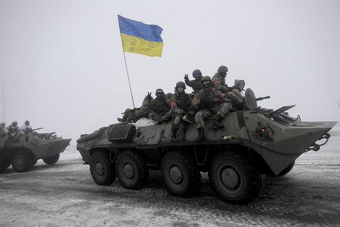 Ukrainian servicemen sit atop an armored personnel carrier (APC) as they patrol Orekhovo village in Lugansk region January 28, 2015.