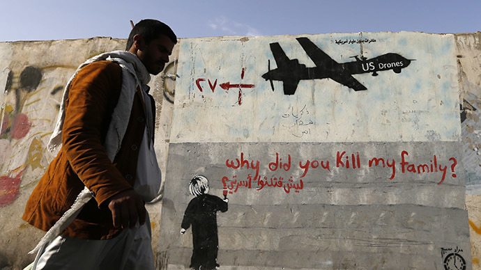 A man walks past a graffiti, denouncing strikes by US drones in Yemen, painted on a wall in Sanaa, November 13, 2014. (Reuters/Khaled Abdullah)