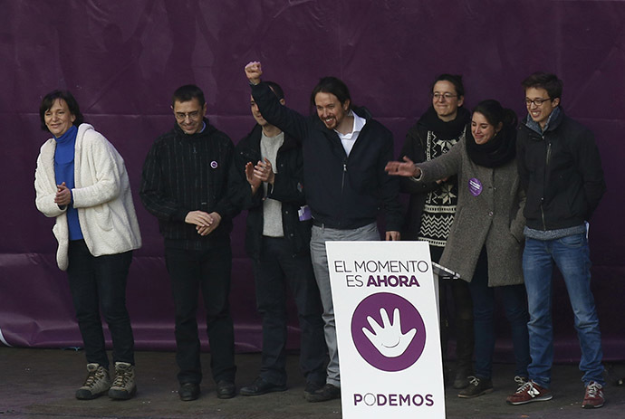 Pablo Iglesias (C), leader of Spain's party "Podemos" (We Can), raises his fist as he stands with his party members on the stage during a rally called by Podemos, at Madrid's Puerta del Sol landmark January 31, 2015. (Reuters/Sergio Perez)