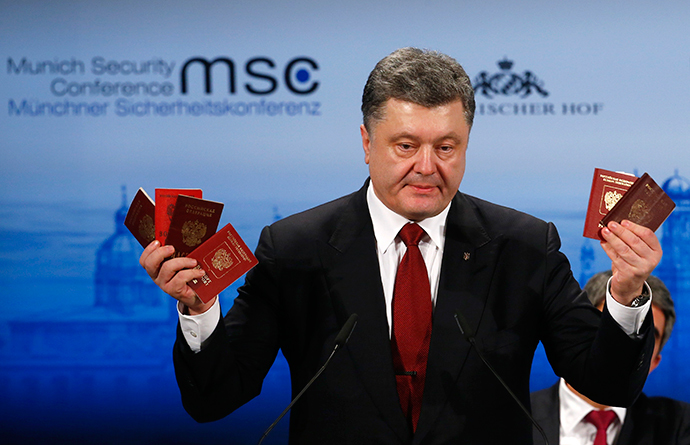 Ukraine's President Petro Poroshenko holds what he claims to be Russian passports proving the presence of Russian troops in Ukraine. Munich, February 7, 2015. (Reuters / Michael Dalder)