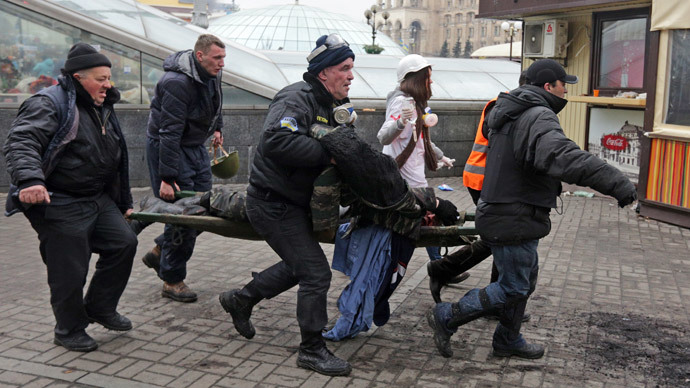 A wounded protester is rushed to a vehicle following violence in Independence Square in Kiev February 20, 2014. (Reuters / Konstantin Chernichkin)
