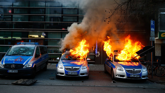 German police cars set on fire by anti-capitalist protesters burn outside the European Central Bank (ECB) building hours before the official opening of its new headquarters in Frankfurt March 18, 2015. (Reuters / Kai Pfaffenbach)