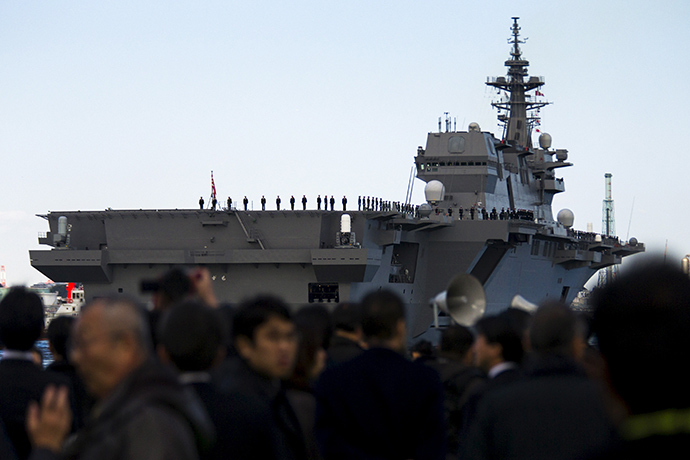 People watch the departure of the Izumo warship from the harbour of Japan United Marine shipyard in Yokohama, south of Tokyo March 25, 2015 (Reuters / Thomas Peter)