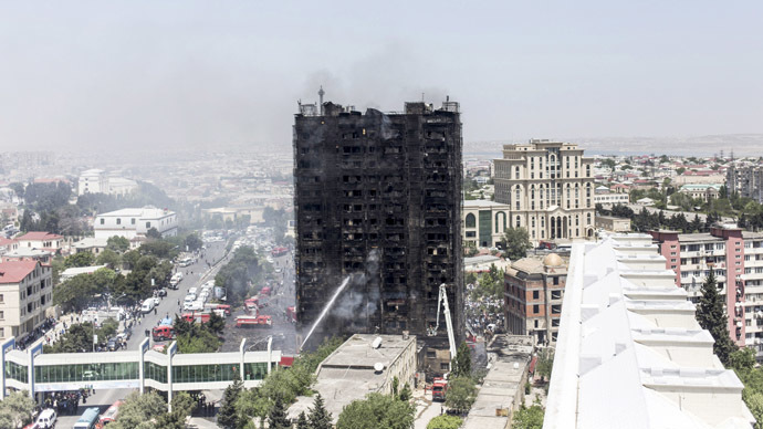 A burnt multi-storey residential building is seen in Baku, Azerbaijan, May 19, 2015. (Reuters/Ehtiram Jabi)