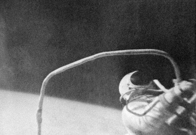 Alexei Leonov, Pilot-Cosmonaut of the USSR, leaving Voskhod 2 spacecraft to take his first step into space. March 18-19, 1965. Reproduction of a book photo. (RIA Novosti)