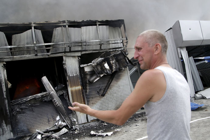 A man reacts next to a shop which was damaged by a recent shelling, at a local market in Donetsk, Ukraine, June 3, 2015. (Reuters/Alexander Ermochenko)