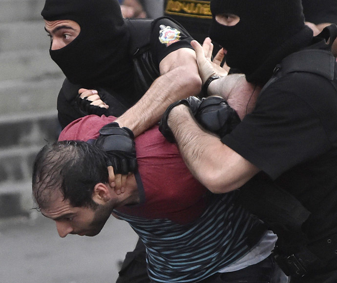 A demonstrator is detained by riot police during a rally against a recent decision to raise public electricity prices in Yerevan, Armenia, June 23, 2015. (Reuters / Vahram Baghdasaryan)