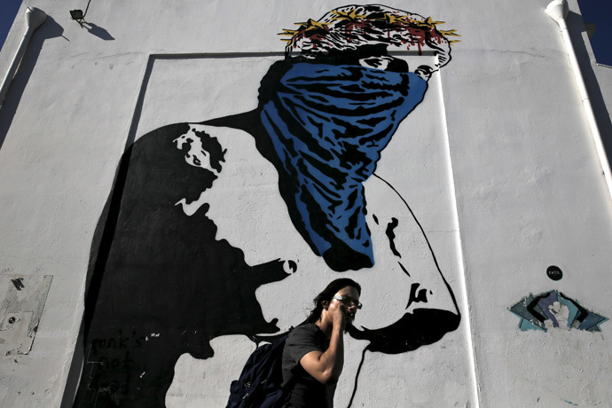 Graffiti "Athena vs Europa, Resist vs Submit" made by French street artist Goin in Athens (Reuters / Alkis Konstantinidis)