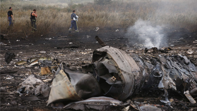 Emergencies Ministry members walk at the site of a Malaysia Airlines Boeing 777 plane crash, MH17, near the settlement of Grabovo in the Donetsk region, July 17, 2014. (Reuters / Maxim Zmeyev)