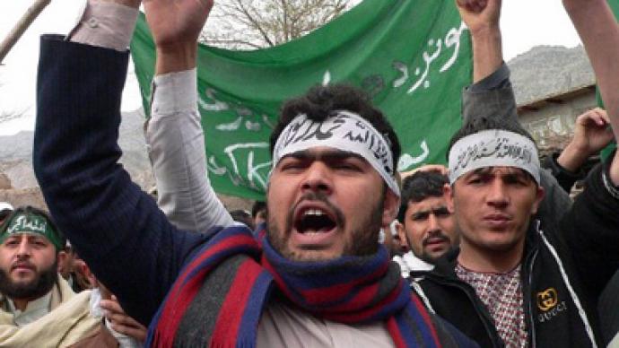 Afghan soldier killed at massacre scene as Afghans rage on streets
