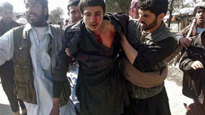 Afghan soldier killed at massacre scene as Afghans rage on streets