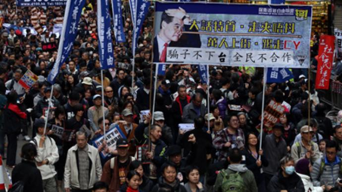 Tens of thousands march in rival protests over Hong Kong’s leader