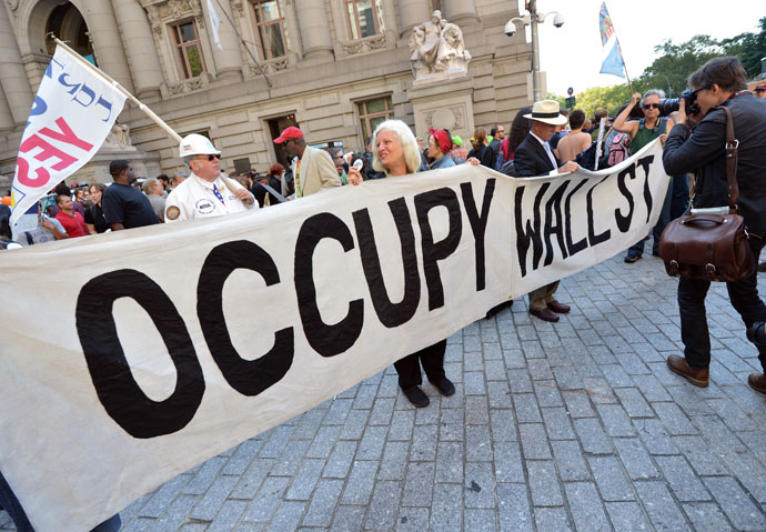 People hold a banner at the Occupy Wall Street.(AFP Photo / Stan Honda)