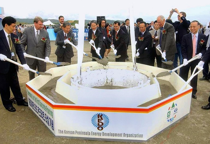 This file photo dated 07 August 2002 shows officials of the Korean Peninsula Energy Development Organization placing the first concrete in the foundation for a nuclear reactor in the Light Water Reactor project, being built under the so-called Agreed Framework signed by Pyongyang and Washington in 1994, at Kumho in North Korea's northeastern coastal. (AFP Photo)