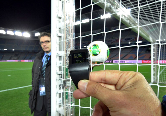 This photo taken on December 5, 2012 shows a FIFA official displaying new goal-line technology developed by GoalRef. (AFP Photo / Yoshikazu Tsuno)