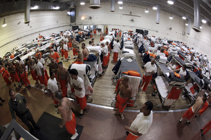 Inmates walk around a gymnasium where they are housed due to overcrowding at the California Institution for Men state prison in Chino, California, June 3, 2011. (Reuters/Lucy Nicholson)