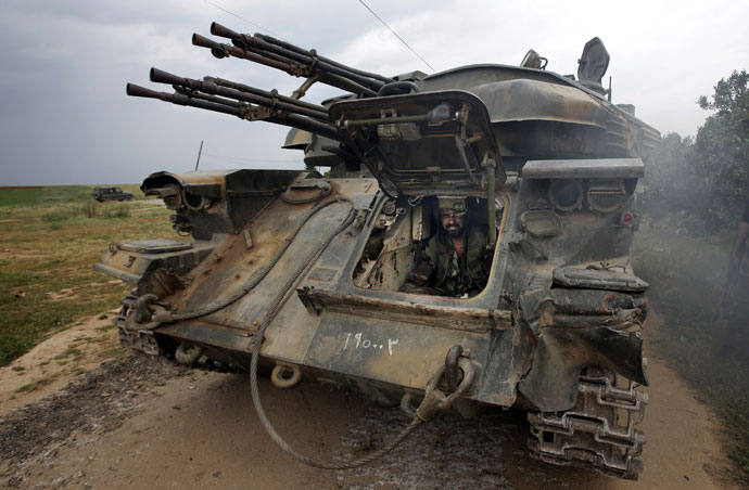 A Syrian soldier sits inside a tank as troops take control of the village of Western Dumayna, some seven kilometers north of the rebel-held city of Qusayr, on May 13, 2013.(AFP Photo / Joseph Eid)
