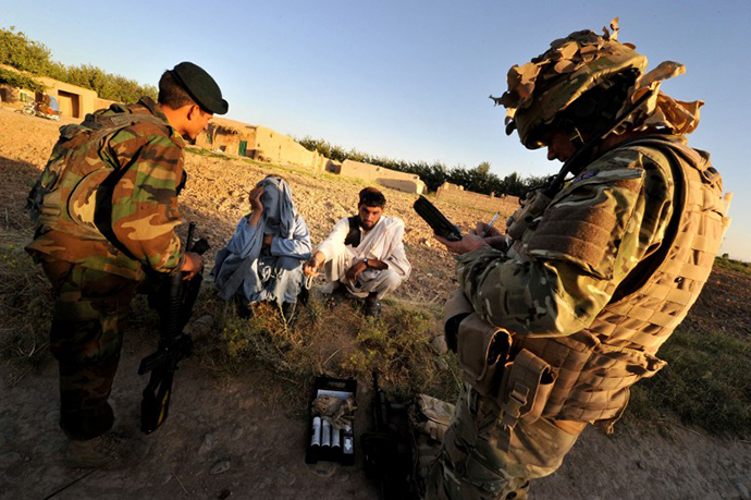 Sergeant Howley of the Royal Military Police attached to 1st Battalion the Royal Gurkha Rifles writes down information during a patrol in Nahr e Saraj, Helmand. (AFP Photo / Bay Ismoyo)