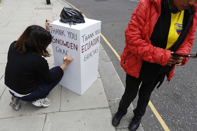 A supporter of Edward Snowden writes a message on a board outside the Embassy of Ecuador in London June 24, 2013. (Reuters)