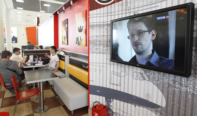 A television screen shows former U.S. spy agency contractor Edward Snowden during a news bulletin at a cafe at Moscow's Sheremetyevo airport June 26, 2013. (Reuters)