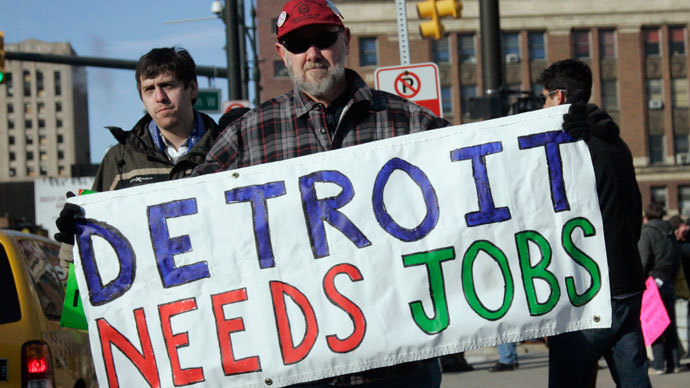 Chrysler Transport worker James Theisen carries a "Detroit Needs Jobs" sign as he joins a demonstration of about a dozen workers demanding jobs, in front of Cobo Center in Detroit.(Reuters / Rebecca Cook)
