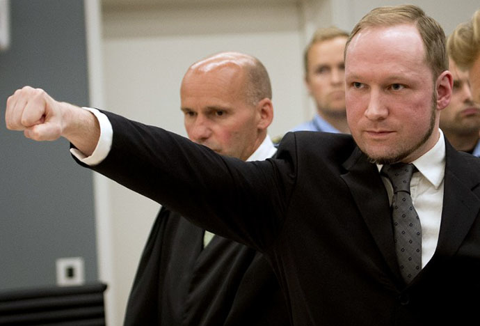Self confessed mass murderer Anders Behring Breivik raises his fist in a right wing salute after being sentenced to 21 years in prison, in court room 250 at Oslo District Court on August 24, 2012. (AFP Photo / Odd Andersen)