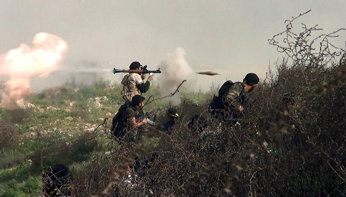 An image grab taken from a video shows an opposition fighter firing an rocket propelled grenade (RPG) on August 26, 2013 during clashes with regime forces over the strategic area of Khanasser, situated on the only road linking Aleppo to central Syria. (AFP Photo)