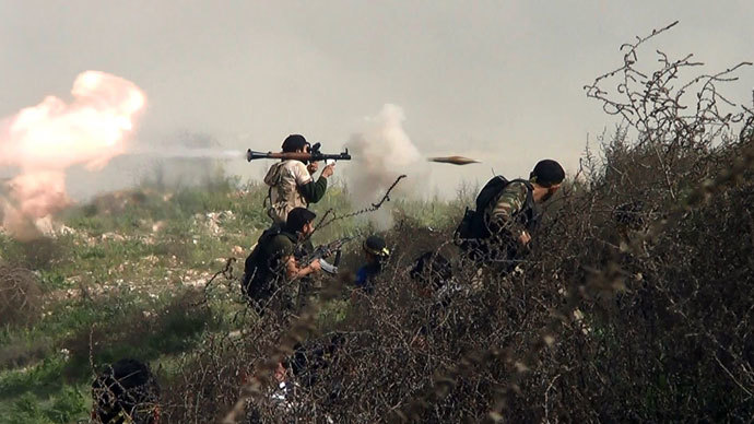An opposition fighter firing an rocket propelled grenade (RPG) on August 26, 2013 during clashes with regime forces over the strategic area of Khanasser, situated on the only road linking Aleppo to central Syria.(AFP Photo / Salah Al-Ashkar)