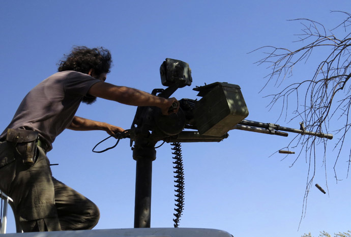 A Free Syrian Army fighter fires his weapon during what the FSA said were clashes with forces loyal to Syria's President Bashar al-Assad in Idlib, September 9, 2013. Picture taken September 9, 2013. (Reuters/Muhammad Qadour)