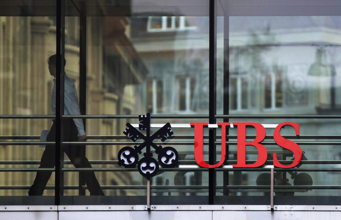 A man walks past a logo of Swiss bank UBS at a building in Zurich (Reuters/Michael Buholzer)