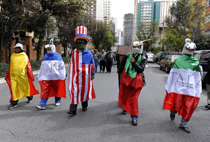 Protesters march towards the US embassy in La Paz on July 8, 2013 to burn an effigy of US President Barack Obama and a coffin with flags of Spain, Portugal, France and Italy, a week after Bolivian President Evo Morales's plane, flying home from a trip to Moscow last week, was forced to make an unscheduled stopover in Vienna after these four European nations temporarily closed their airspace over groundless rumours that fugitive US intelligence leaker Edward Snowden was aboard the jet. (AFP Photo / Jorge Bernal)