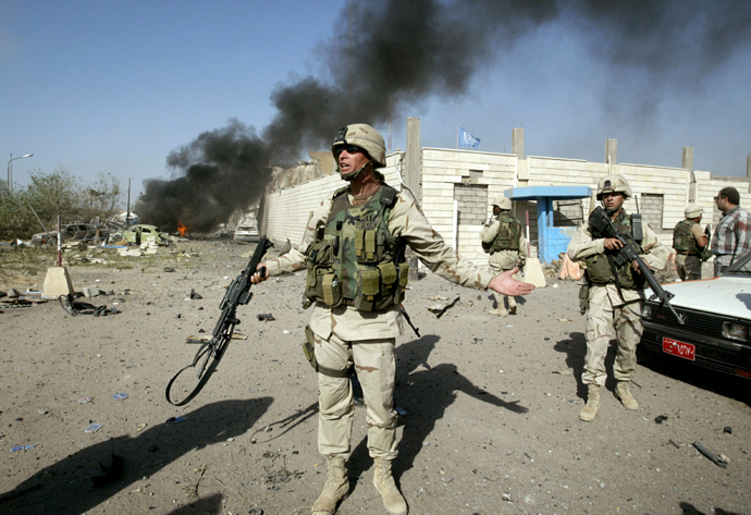 A U.S. soldier directs people outside of the United Nation headquarters in Baghdad August 19, 2003. (Reuters)