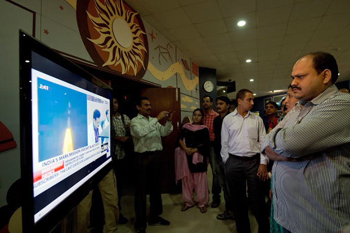 Indian visitors to the Nehru Planetarium watch the live telecast of the launch of India's Mars Orbiter Mission in New Delhi on November 5, 2013. (AFP Photo / Prakash Singh)
