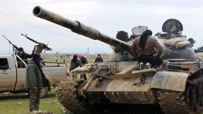 Free Syrian Army fighters look at a tank taken by defectors from the regular Syrian Army in Al Qusayr .(Reuters / Samuel Jamison)