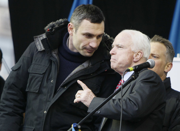 U.S. Senator John McCain (R) speaks with Ukrainian opposition leader Vitaly Klitschko (L) during a mass rally by pro-European integration protesters at Independence Square in Kiev December 15, 2013. (Reuters/Gleb Garanich)